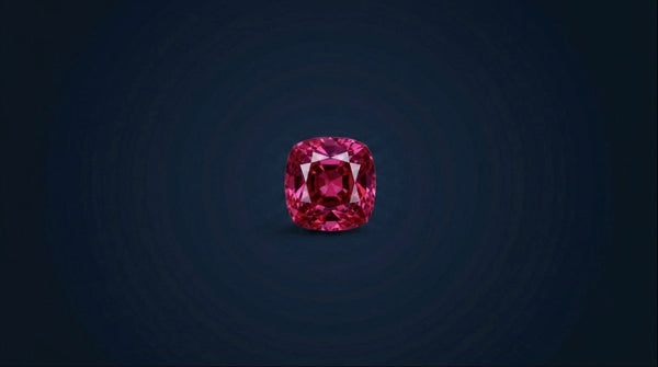 Natural untreated Mogok spinel loose gemstone on navy background