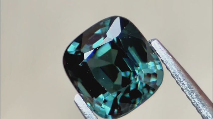 Teal green cushion-cut spinel, 1.44ct, with eye-clean clarity and brilliant fire, ideal for custom engagement rings or luxury fine jewellery.