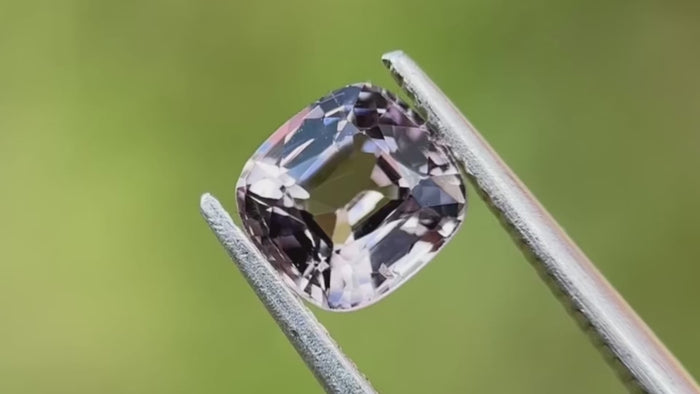 Natural, untreated grey spinel, set against a light green background. Originating from Myanmar, it has a hardness of 8. Ideal for creating unique custom rings.