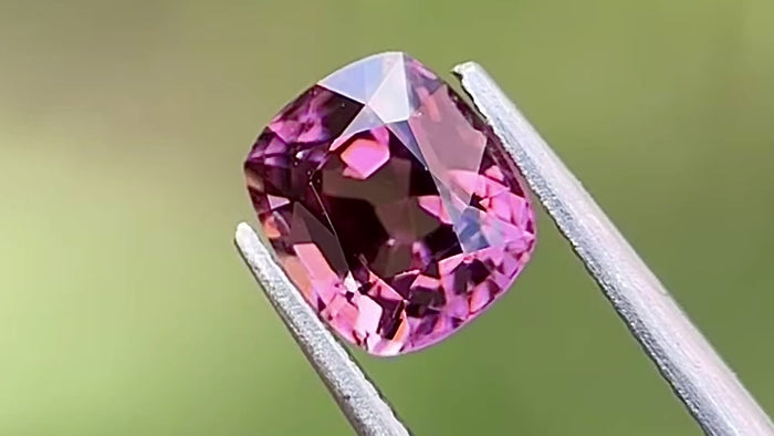 Vivid purple cushion-cut natural spinel gemstone from Myanmar, captured in natural daylight to highlight its brilliance and clarity. Perfect for custom fine jewellery pieces.