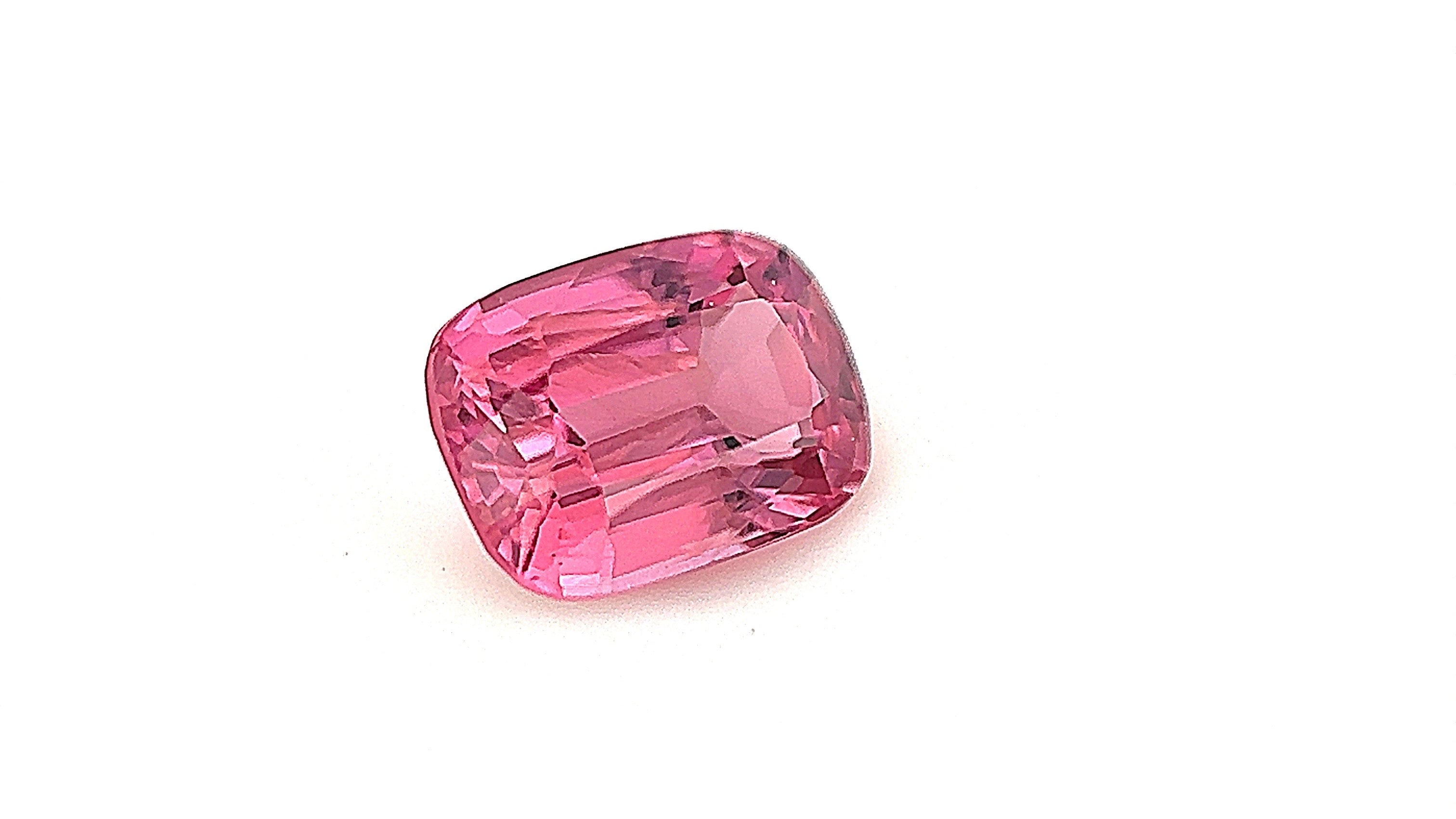 Close-up of a vivid pink spinel, 0.95ct, captured in a gemlight box to highlight its brilliance and eye-clean clarity. A stunning choice for millennials and Gen Z looking for a unique engagement ring.